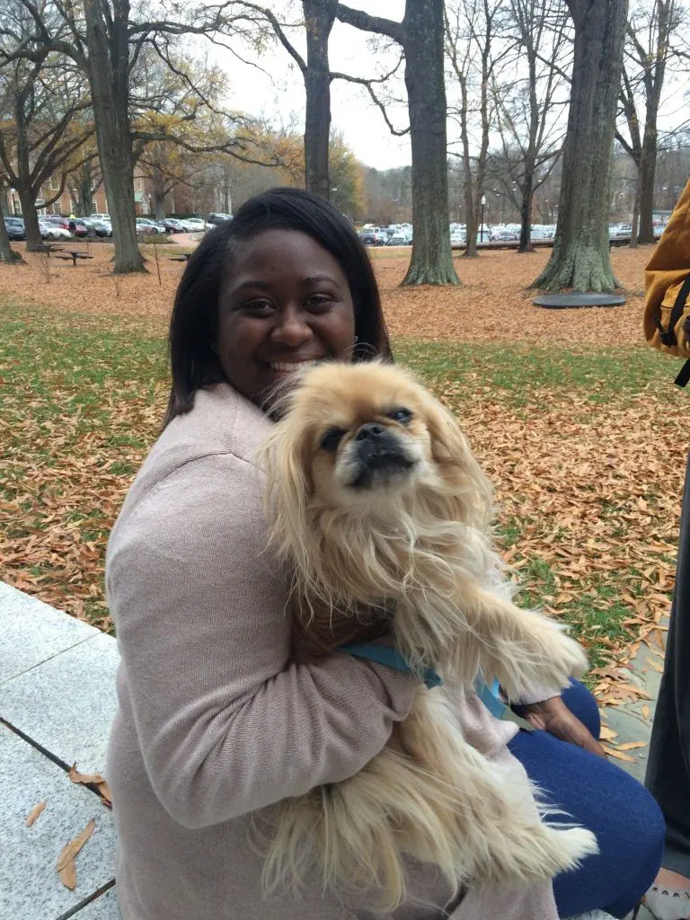 Student hugs puppy at event