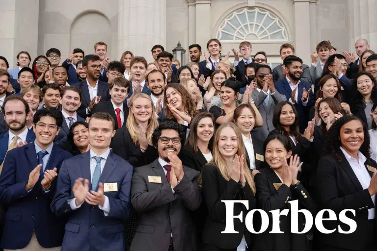 An image of students at Wake Forest School of Business, celebrating. This image is associated with a highlight of a Forbes news article noting the School's successful focus on shifting preferences among prospective applicants.