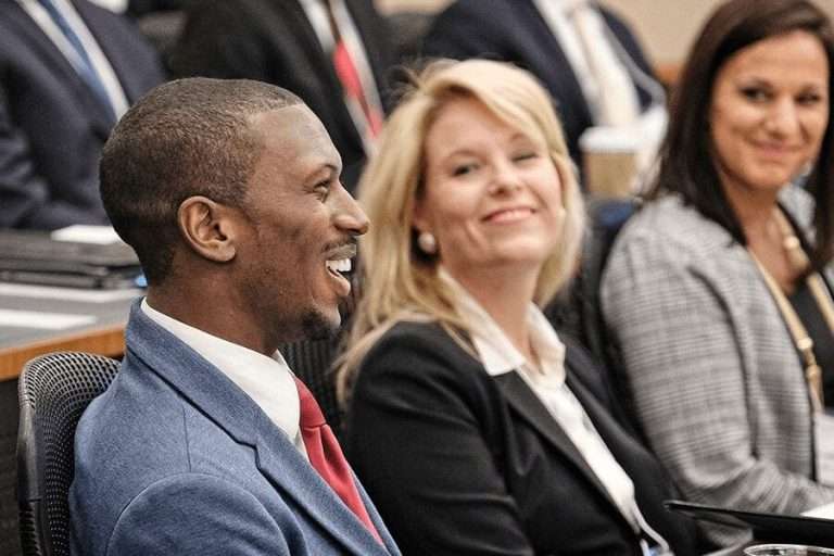 Working professional students in the Wake Forest University MBA program gather for class