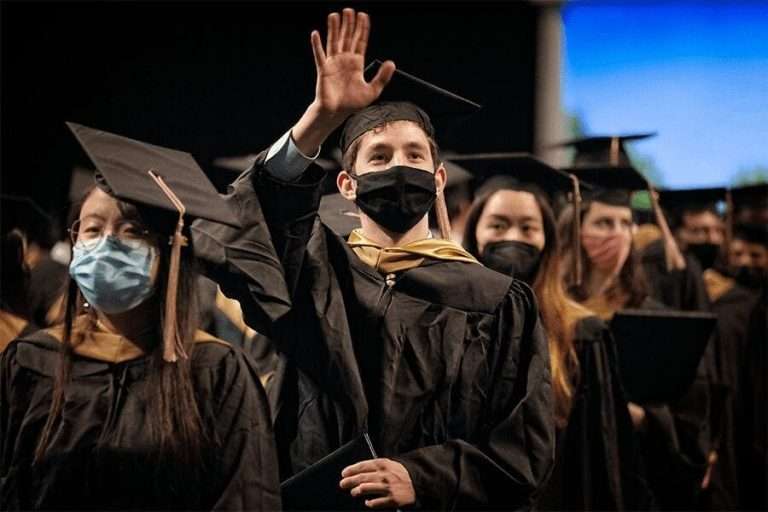 Student waves at May 2021 hooding ceremony