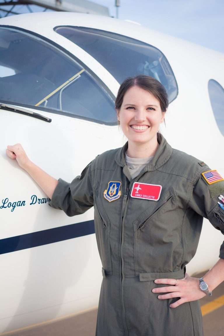 woman standing next to plane