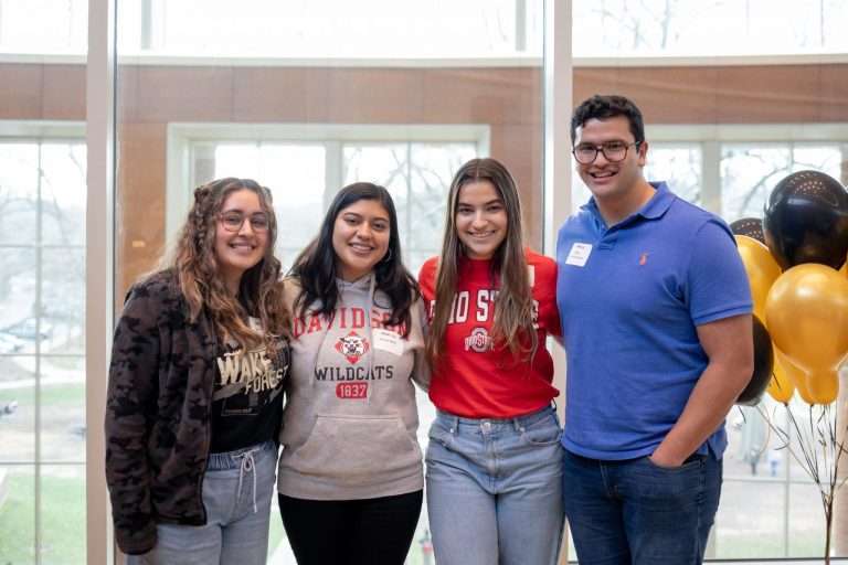 College students exploring the business programs posing for a group picture.