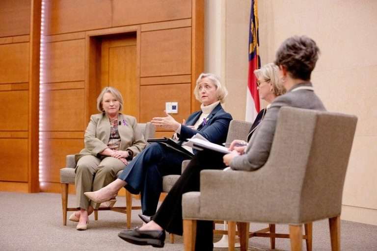 four women seating and talking