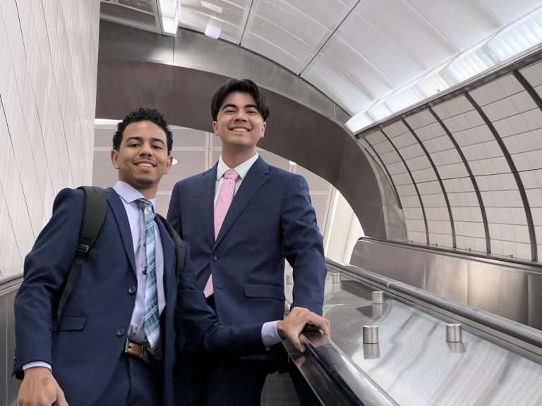 men in the subway smiling