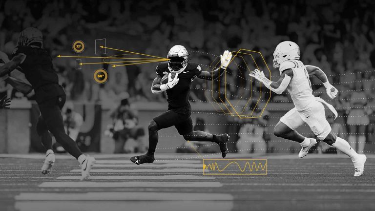 Scene of Wake Forest football player in the midst of data analysis.