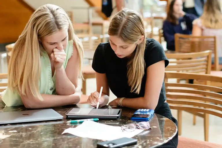 Two students working together with a smart tablet